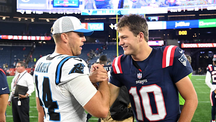 New England Patriots quarterback Drake Maye high-fives Carolina Panthers long snapper JJ Jansen. New England Patriots quarterback Drake Maye high-fives Carolina Panthers long snapper JJ Jansen.