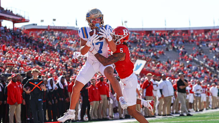 Oct 19, 2024; Piscataway, New Jersey, USA; UCLA Bruins wide receiver Logan Loya (17) catches a touchdown pass as Rutgers Scarlet Knights defensive back Kaj Sanders (5) defends during the first half at SHI Stadium. Mandatory Credit: Vincent Carchietta-Imagn Images