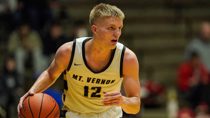 Mt. Vernon guard Luke Ertel rushes up the court during the game at New Castle Fieldhouse
