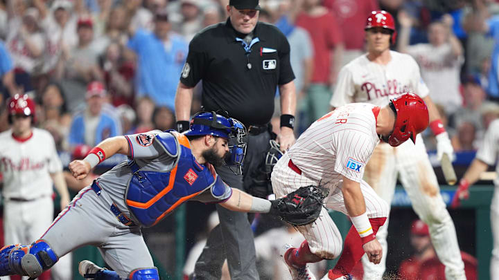 Jun 22, 2025; Philadelphia, Pennsylvania, USA; Philadelphia Phillies designated hitter Kyle Schwarber (12) slides home to score against New York Mets catcher Luis Torrens (13) in the seventh inning at Citizens Bank Park. Mandatory Credit: Kyle Ross-Imagn Images