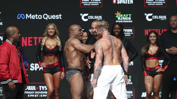 Mike Tyson (left) slaps Jake Paul (right) after weighing in at the Toyota Music Factory.  