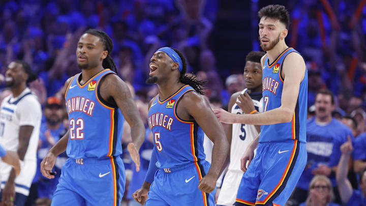May 22, 2025; Oklahoma City, Oklahoma, USA; Oklahoma City Thunder guard Luguentz Dort (5) celebrates with guard Cason Wallace (22) and forward Chet Holmgren (7) after a play against the Minnesota Timberwolves in the third quarter during game two of the western conference finals for the 2025 NBA Playoffs at Paycom Center. Mandatory Credit: Alonzo Adams-Imagn Images