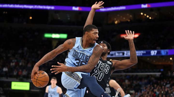 Dec 13, 2024; Memphis, Tennessee, USA; Memphis Grizzlies guard Marcus Smart (36) passes the ball as Brooklyn Nets center Day'Ron Sharpe (20) defends during the third quarter at FedExForum. Mandatory Credit: Petre Thomas-Imagn Images