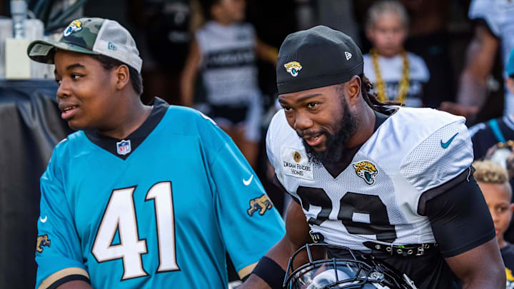 Jacksonville Jaguars safety Eric Murray (29) shakes hands with a young man during Helmet Walk before an NFL scrimmage at EverBank Stadium Friday August 1, 2025, in Jacksonville, Fla. [Doug Engle/Florida Times-Union]