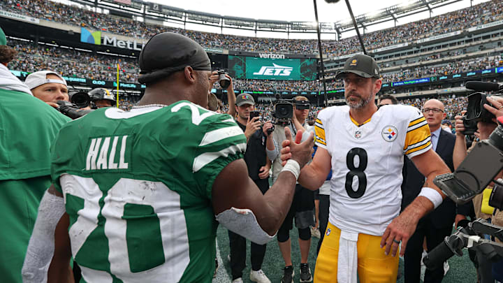 Sep 7, 2025; East Rutherford, New Jersey, USA; Pittsburgh Steelers quarterback Aaron Rodgers (8) shakes hands with New York Jets running back Breece Hall (20) after the game at MetLife Stadium. Mandatory Credit: Vincent Carchietta-Imagn Images