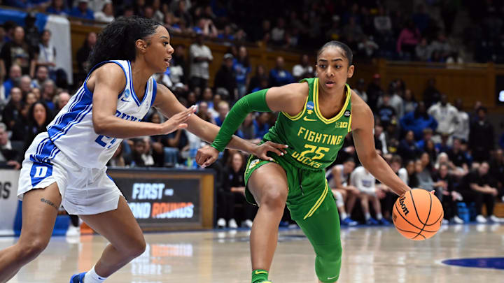 Mar 23, 2025; Durham, NC, USA; Oregon Ducks guard Deja Kelly (25) drives to the basket as Duke Blue Devils guard Reigan Richardson (24) defends during the second half at Cameron Indoor Stadium. The Blue Devils won 59-53. Mandatory Credit: Rob Kinnan-Imagn Images