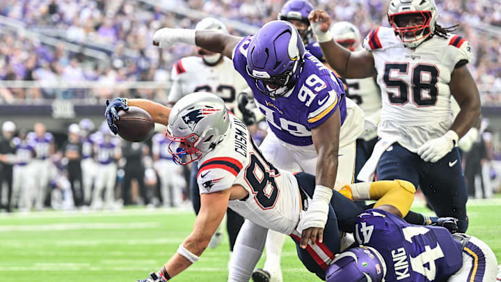 Aug 16, 2025; Minneapolis, Minnesota, USA;  New England Patriots wide receiver Efton Chism III (86) scores a touchdown as Minnesota Vikings linebacker Kobe King (41) and defensive end Alex Williams (99) attempt to make the stop during the second quarter at U.S. Bank Stadium. Mandatory Credit: Jeffrey Becker-Imagn Images