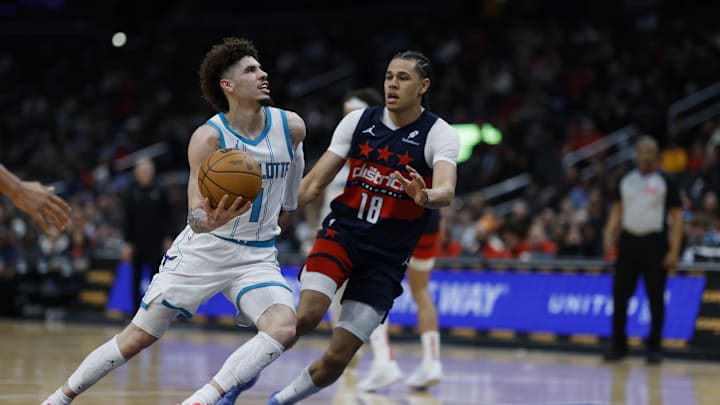 Dec 26, 2024; Washington, District of Columbia, USA; Charlotte Hornets guard LaMelo Ball (1) drives to the basket as Washington Wizards forward Kyshawn George (18) defends in the second quarter at Capital One Arena. Mandatory Credit: Geoff Burke-Imagn Images Dec 26, 2024; Washington, District of Columbia, USA; Charlotte Hornets guard LaMelo Ball (1) drives to the basket as Washington Wizards forward Kyshawn George (18) defends in the second quarter at Capital One Arena. Mandatory Credit: Geoff Burke-Imagn Images