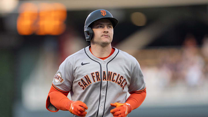May 10, 2025; Minneapolis, Minnesota, USA; San Francisco Giants catcher Patrick Bailey (14) walks back to the dugout after hitting a fly ball caught by Minnesota Twins third base Brooks Lee (2) in the fifth inning at Target Field. 