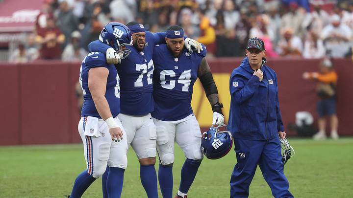 Oct 11, 2026; Landover, Maryland, USA; New York Giants offensive line Jermaine Eluemunor (72) is helped off the field after an injury during the third quarter against the Washington Commanders at Northwest Stadium. Oct 11, 2026; Landover, Maryland, USA; New York Giants offensive line Jermaine Eluemunor (72) is helped off the field after an injury during the third quarter against the Washington Commanders at Northwest Stadium.