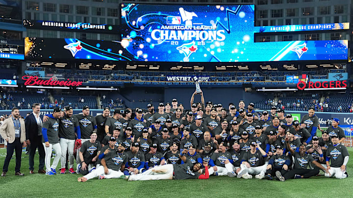 Oct 20, 2025; Toronto, Ontario, CAN; The Toronto Blue Jays players pose for a team photo after defeating the Seattle Mariners in game seven of the ALCS round for the 2025 MLB playoffs at Rogers Centre. Mandatory Credit: Nick Turchiaro-Imagn Images Oct 20, 2025; Toronto, Ontario, CAN; The Toronto Blue Jays players pose for a team photo after defeating the Seattle Mariners in game seven of the ALCS round for the 2025 MLB playoffs at Rogers Centre. Mandatory Credit: Nick Turchiaro-Imagn Images