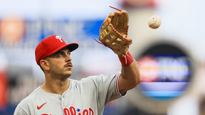 Aug 11, 2025; Cincinnati, Ohio, USA; Philadelphia Phillies third baseman Otto Kemp (4) catches a ball as he walks off the field at the end of the third inning in the game against the Cincinnati Reds at Great American Ball Park. Mandatory Credit: Katie Stratman-Imagn Images