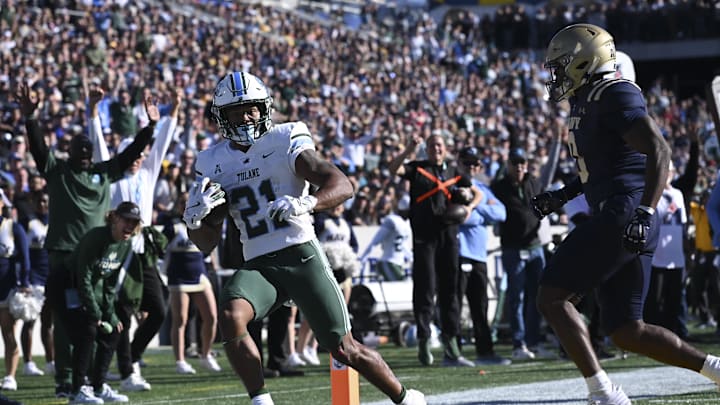 Makhi Hughes scores against Navy last season for the Tulane Green Wave. 