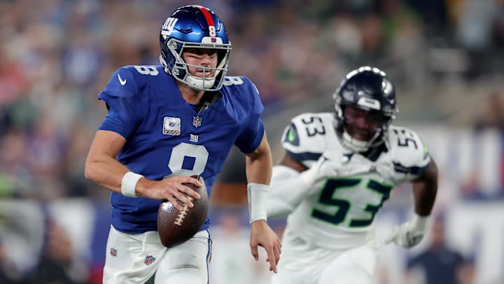 Oct 2, 2023; East Rutherford, New Jersey, USA; New York Giants quarterback Daniel Jones (8) runs with the ball against Seattle Seahawks linebacker Boye Mafe (53) during the third quarter at MetLife Stadium. Mandatory Credit: Brad Penner-Imagn Images