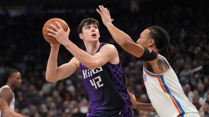 Nov 7, 2025; Sacramento, California, USA; Sacramento Kings center Maxime Raynaud (42) holds onto the ball next to Oklahoma City Thunder forward Jaylin Williams (6) in the second quarter at the Golden 1 Center. Mandatory Credit: Cary Edmondson-Imagn Images