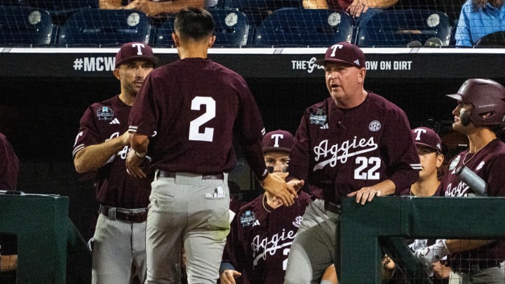 Jun 19, 2024; Omaha, NE, USA; Texas A&M Aggies head coach Jim Schlossnagle high fives shortstop Ali Camarillo (2) after scoring a run against the Florida Gators during the ninth inning at Charles Schwab Field Omaha. Mandatory Credit: Dylan Widger-USA TODAY Sports