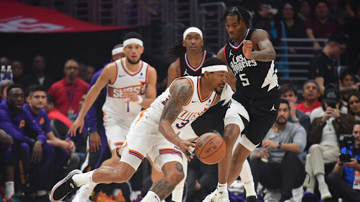 Apr 10, 2024; Los Angeles, California, USA;  Phoenix Suns guard Bradley Beal (3) moves the ball against Los Angeles Clippers guard Bones Hyland (5) and guard Terance Mann (14) during the first half at Crypto.com Arena. Mandatory Credit: Gary A. Vasquez-Imagn Images
