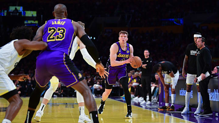 Nov 19, 2024; Los Angeles, California, USA; Los Angeles Lakers guard Dalton Knecht (4) passes the ball to forward LeBron James (23) against the Utah Jazz during the first half at Crypto.com Arena. Mandatory Credit: Gary A. Vasquez-Imagn Images