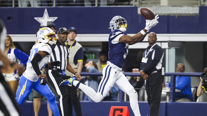 Dec 21, 2025; Arlington, Texas, USA; Dallas Cowboys wide receiver George Pickens (3) catches a touchdown pass against Los Angeles Chargers cornerback Cam Hart (20) during the second quarter at AT&T Stadium. Mandatory Credit: Kevin Jairaj-Imagn Images