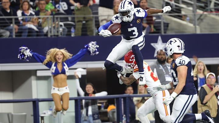 Dallas Cowboys wide receiver George Pickens hurdles Kansas City Chiefs cornerback Trent McDuffie