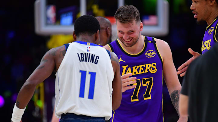 Feb 25, 2025; Los Angeles, California, USA; Los Angeles Lakers guard Luka Doncic (77) reacts with Dallas Mavericks guard Kyrie Irving (11) during the first quarter at Crypto.com Arena. Mandatory Credit: Gary A. Vasquez-Imagn Images