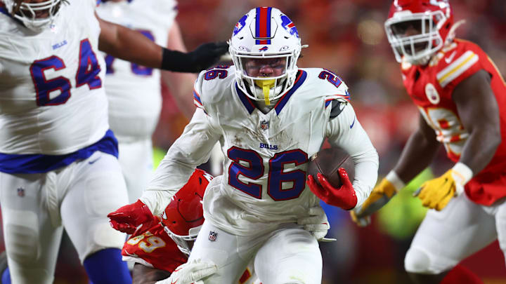 Buffalo Bills running back Ty Johnson (26) rushes the ball past Kansas City Chiefs defensive tackle Mike Pennel Jr. (69) during the second half in the AFC Championship game at GEHA Field at Arrowhead Stadium. 
