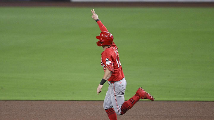 Sep 8, 2025; San Diego, California, USA; Cincinnati Reds left fielder Austin Hays (12) celebrates after hitting a solo home run during the sixth inning against the San Diego Padres at Petco Park. Mandatory Credit: Denis Poroy-Imagn Images