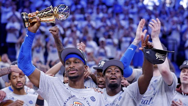 May 28, 2025; Oklahoma City, Oklahoma, USA; Oklahoma City Thunder guard Shai Gilgeous-Alexander (2) celebrates with Magic Johnson West Conference Finals MVP trophy after defeating the Minnesota Timberwolves in game five to win the western conference finals for the 2025 NBA Playoffs at Paycom Center. Mandatory Credit: Alonzo Adams-Imagn Images