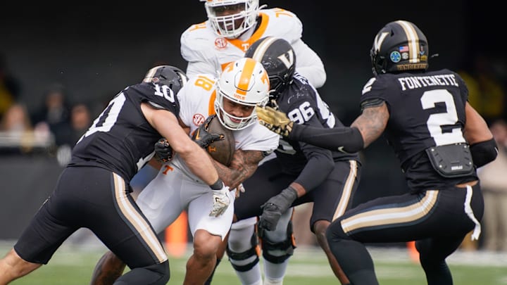 Tennessee running back DeSean Bishop (18) is stopped by Vanderbilt linebacker Langston Patterson (10) during the second quarter at FirstBank Stadium in Nashville, Tenn., Saturday, Nov. 30, 2024.