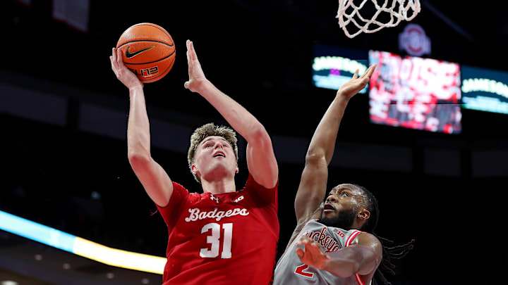 Feb 17, 2026; Columbus, Ohio, USA; Wisconsin Badgers forward Nolan Winter (31) drives to the basket as Ohio State Buckeyes guard Bruce Thornton (2) defends during the first half at Value City Arena.