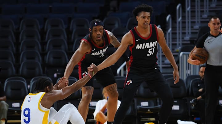 Jul 10, 2024; San Francisco, CA, USA; Los Angeles Lakers guard Bronny James Jr. (9) is helped up by Miami Heat guard Alondes Williams (15) and guard Bryson Warren (51) during the first quarter at Chase Center. Mandatory Credit: Kelley L Cox-Imagn Images