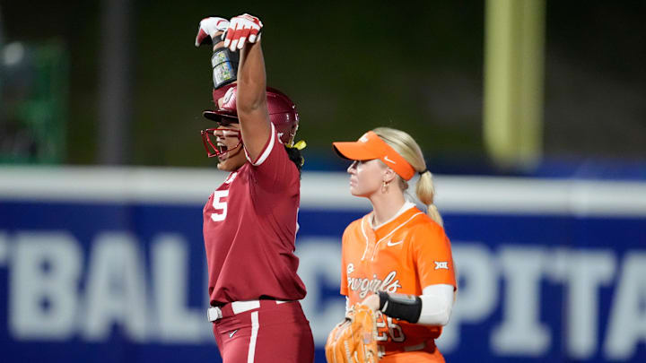 Oklahoma's Ella Parker (5) celebrates a double beside Oklahoma State's Rosie Davis (26) in the fifth inning of a college Bedlam softball game between the University of Oklahoma Sooners (OU) and the Oklahoma State University Cowgirls (OSU) at Devon Park in Oklahoma City, Wednesday, April 9, 2025.