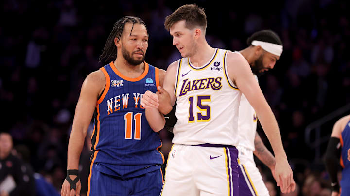 Feb 3, 2024; New York, New York, USA; New York Knicks guard Jalen Brunson (11) grabs Los Angeles Lakers guard Austin Reaves (15) during the fourth quarter at Madison Square Garden. Mandatory Credit: Brad Penner-Imagn Images