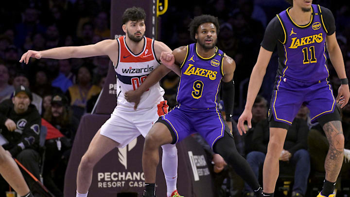 Jan 21, 2025; Los Angeles, California, USA;  Los Angeles Lakers guard Bronny James (9) defends Washington Wizards forward Tristan Vukcevic (00) in the second half at Crypto.com Arena. Mandatory Credit: Jayne Kamin-Oncea-Imagn Images