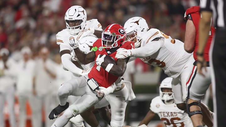 Nov 15, 2025; Athens, Georgia, USA; Georgia Bulldogs wide receiver Zachariah Branch (1) is tackle by Texas Longhorns defensive back Michael Taaffe (16) and defensive tackle Hero Kanu (93) in the first half at Sanford Stadium. Mandatory Credit: Brett Davis-Imagn Images