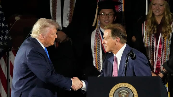 President Donald Trump shakes hands with legendary Alabama football coach Nick Saban before delivering a special commencement address to University of Alabama graduates at Coleman Coliseum on May 1, 2025. Graduation occurs over the weekend.