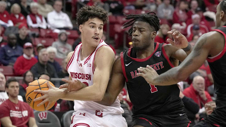 Wisconsin guard Hayden Jones (13) is guarded by Ball State guard Elmore James (1) during the second half of their game Tuesday, November 11, 2025 at the Kohl Center in Madison, Wisconsin. Wisconsin beat Ball State 86-55.
