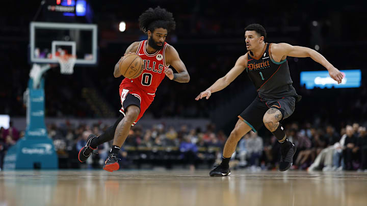 Apr 12, 2024; Washington, District of Columbia, USA; Chicago Bulls guard Coby White (0) drives to the basket as Washington Wizards guard Johnny Davis (1) defends in the second half at Capital One Arena. Mandatory Credit: Geoff Burke-Imagn Images