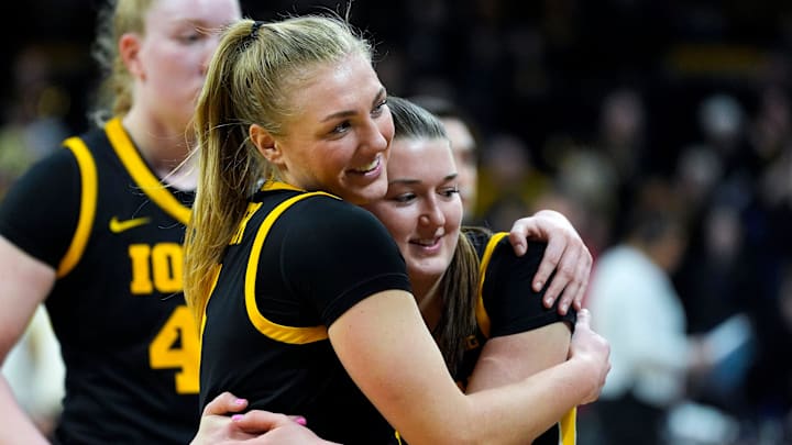 Iowa guard Sydney Affolter (3) hugs Iowa guard Taylor Stremlow (1) after the Hawkeyes defeated Wisconsin 81-66 Sunday, March 2, 2025 at Carver-Hawkeye Arena in Iowa City, Iowa.