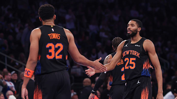Nov 28, 2025; New York, New York, USA; New York Knicks guard Mikal Bridges (25) slaps hands with center Karl-Anthony Towns (32) during the first half against the Milwaukee Bucks at Madison Square Garden. Mandatory Credit: Vincent Carchietta-Imagn Images