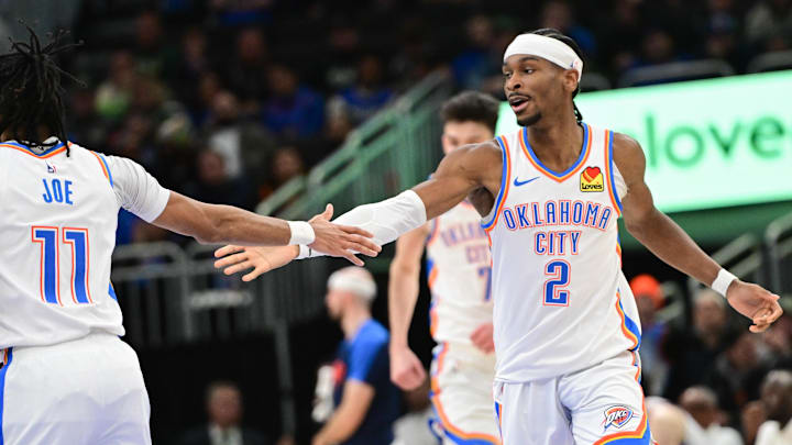 Mar 16, 2025; Milwaukee, Wisconsin, USA; Oklahoma City Thunder guard Shai Gilgeous-Alexander (2) celebrates with  guard Isaiah Joe (11) after score in the fourth quarter against the Milwaukee Bucks at Fiserv Forum. Mandatory Credit: Benny Sieu-Imagn Images