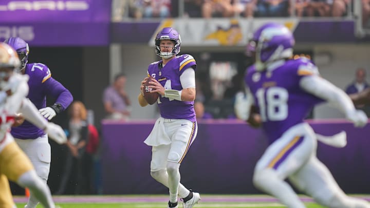 Sep 15, 2024; Minneapolis, Minnesota, USA; Minnesota Vikings quarterback Sam Darnold (14) looks to pass against the San Francisco 49ers in the first quarter at U.S. Bank Stadium. Mandatory Credit: Brad Rempel-Imagn Images
