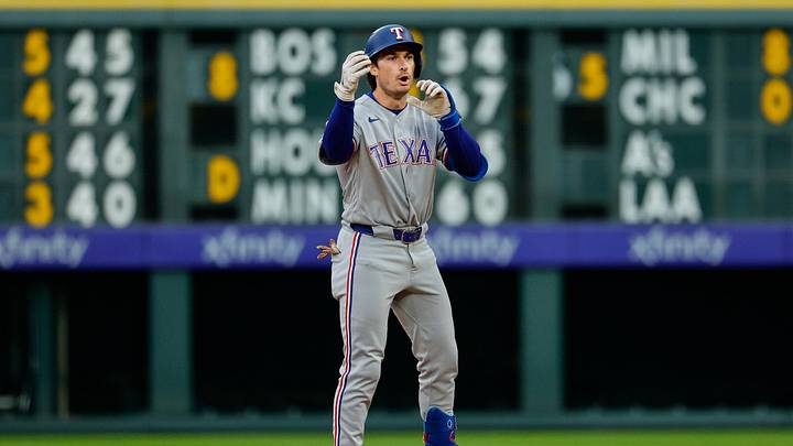 May 18, 2026; Denver, Colorado, USA; Texas Rangers second baseman Justin Foscue (14) reacts on an RBI double in the second inning against the Colorado Rockies at Coors Field. Mandatory Credit: Isaiah J. Downing-Imagn Images