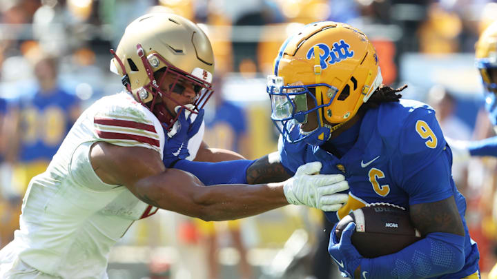 Oct 4, 2025; Pittsburgh, Pennsylvania, USA; Pittsburgh Panthers linebacker Kyle Louis (9) runs after fumble recovery as Boston College Eagles wide receiver Reed Harris (left) attempts to tackle during the second quarter at Acrisure Stadium. Mandatory Credit: Charles LeClaire-Imagn Images Oct 4, 2025; Pittsburgh, Pennsylvania, USA; Pittsburgh Panthers linebacker Kyle Louis (9) runs after fumble recovery as Boston College Eagles wide receiver Reed Harris (left) attempts to tackle during the second quarter at Acrisure Stadium. Mandatory Credit: Charles LeClaire-Imagn Images