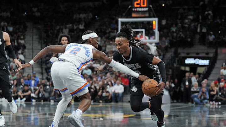 Nov 19, 2024; San Antonio, Texas, USA;  Oklahoma City Thunder guard Shai Gilgeous-Alexander (2) fouls San Antonio Spurs guard Stephon Castle (5) in the first half at Frost Bank Center. Mandatory Credit: Daniel Dunn-Imagn Images