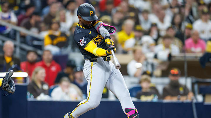 May 31, 2025; San Diego, California, USA; Pittsburgh Pirates designated hitter Andrew McCutchen (22) hits a single during the seventh inning against the San Diego Padres at Petco Park. Mandatory Credit: David Frerker-Imagn Images