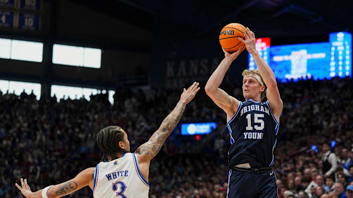 Jan 31, 2026; Lawrence, Kansas, USA; BYU Cougars guard Richie Saunders (15) shoots against BYU Cougars forward AJ Dybantsa (3) during the first half at Mizzou Arena. Mandatory Credit: Jay Biggerstaff-Imagn Images