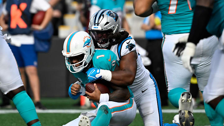 Oct 5, 2025; Charlotte, North Carolina, USA; Carolina Panthers linebacker Patrick Jones II (91) sacks Miami Dolphins quarterback Tua Tagovailoa (1) on third down late in the fourth quarter at Bank of America Stadium. Mandatory Credit: Bob Donnan-Imagn Images