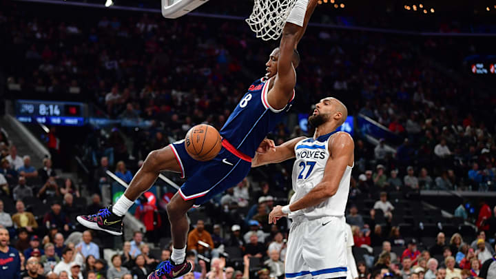 Mar 11, 2026; Inglewood, California, USA; Los Angeles Clippers guard Kris Dunn (8) dunks for the basket in front of Minnesota Timberwolves center Rudy Gobert (27) during the second half at Intuit Dome. Mandatory Credit: Gary A. Vasquez-Imagn Images