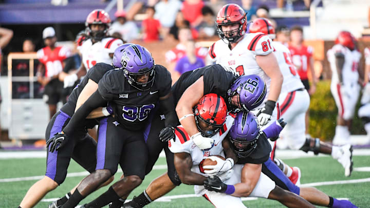 North Greenville Crusaders linebacker Taylor Anderson (6) gets tackled by Furman Paladins safety
